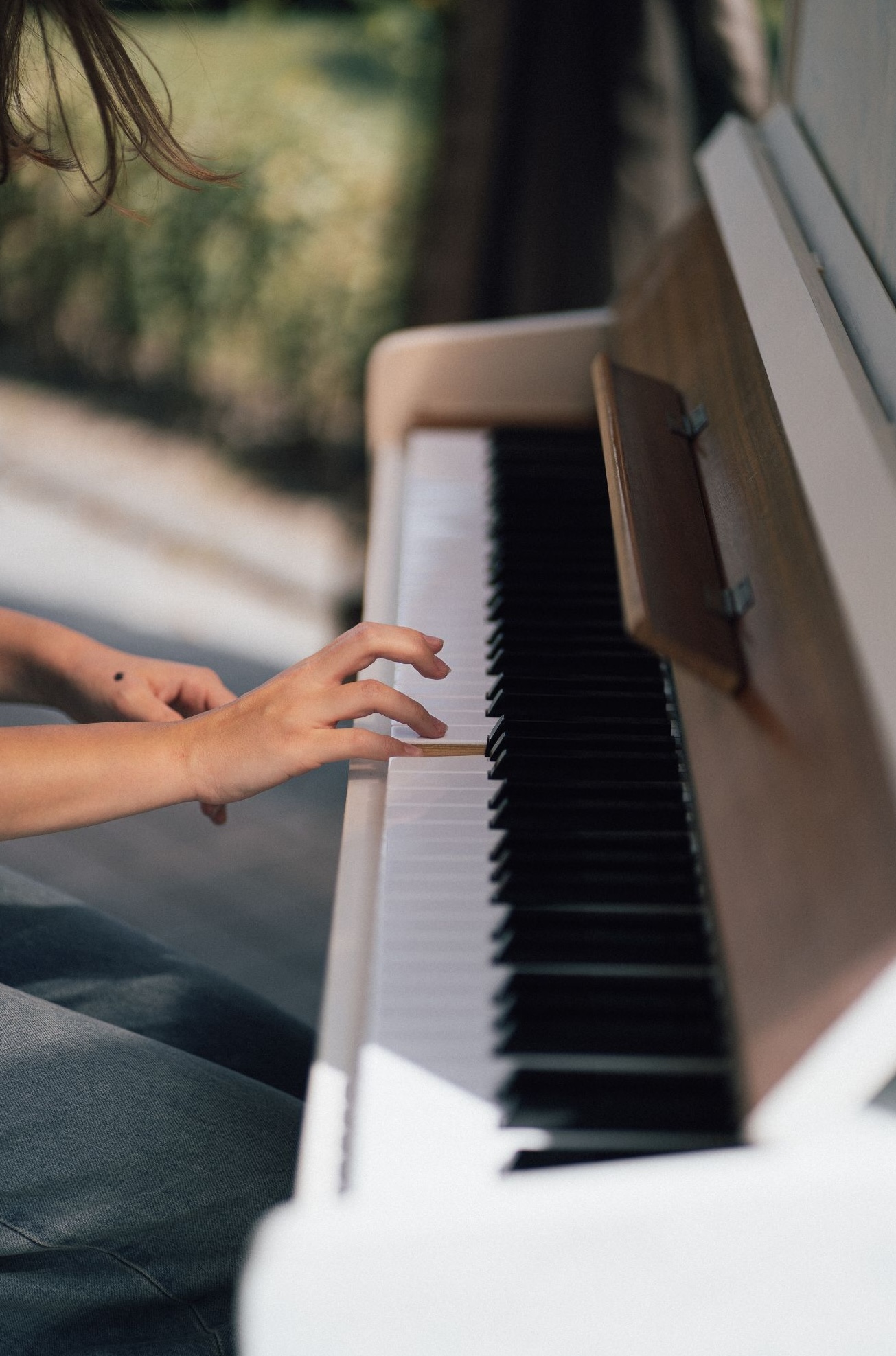 Hands playing piano during a casual music lesson