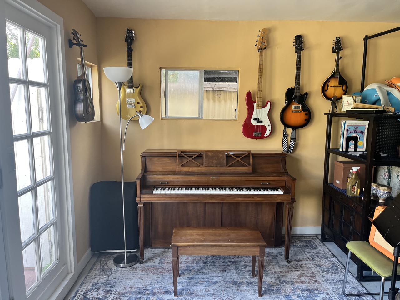 Evergrow Music School teaching studio with piano and guitars